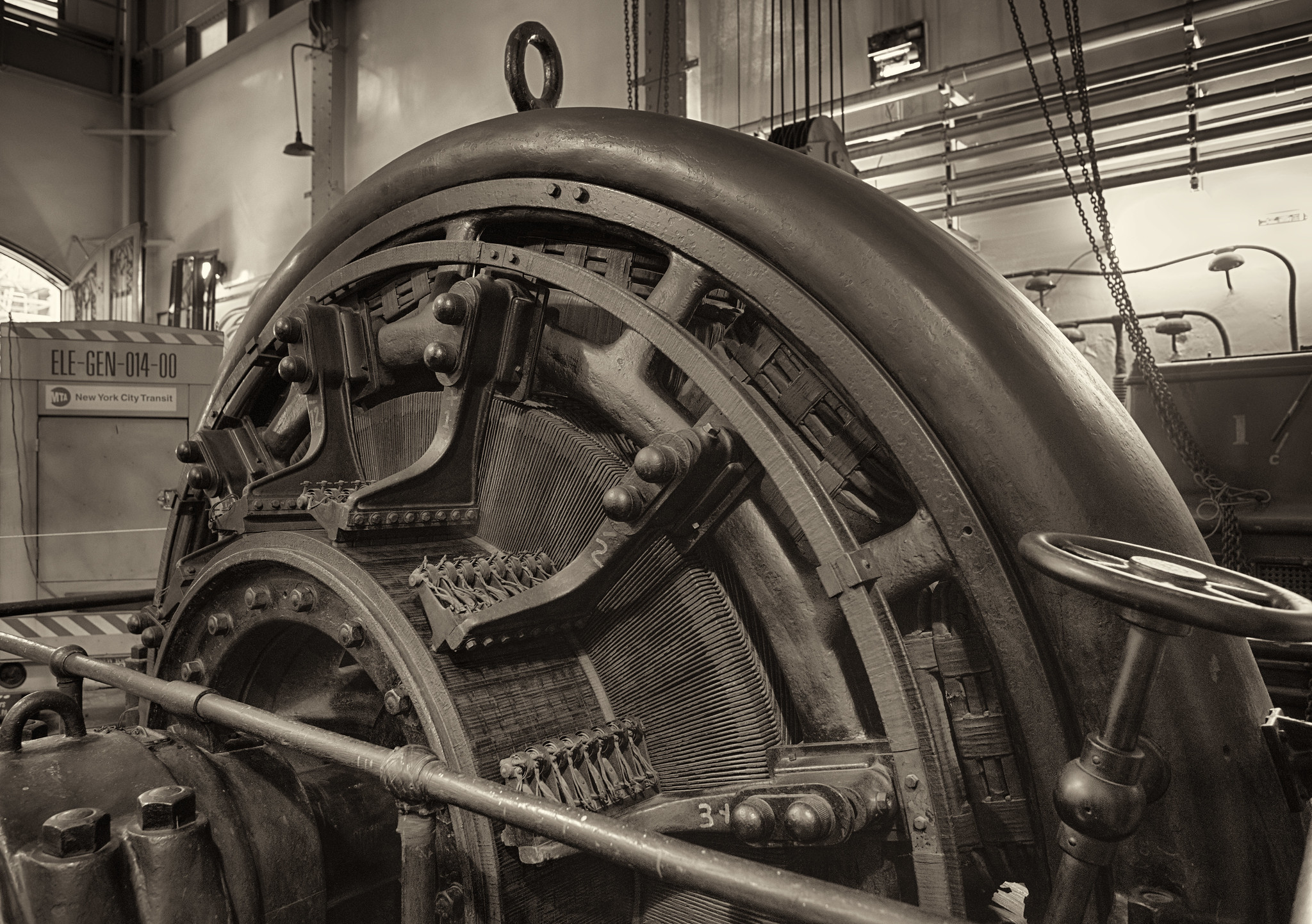 An early 20th century electromechanical "rotary converter", resembling a generator, in an industrial space.