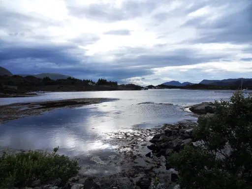A mountainous landscape in Norway, with a lake in the foreground.
